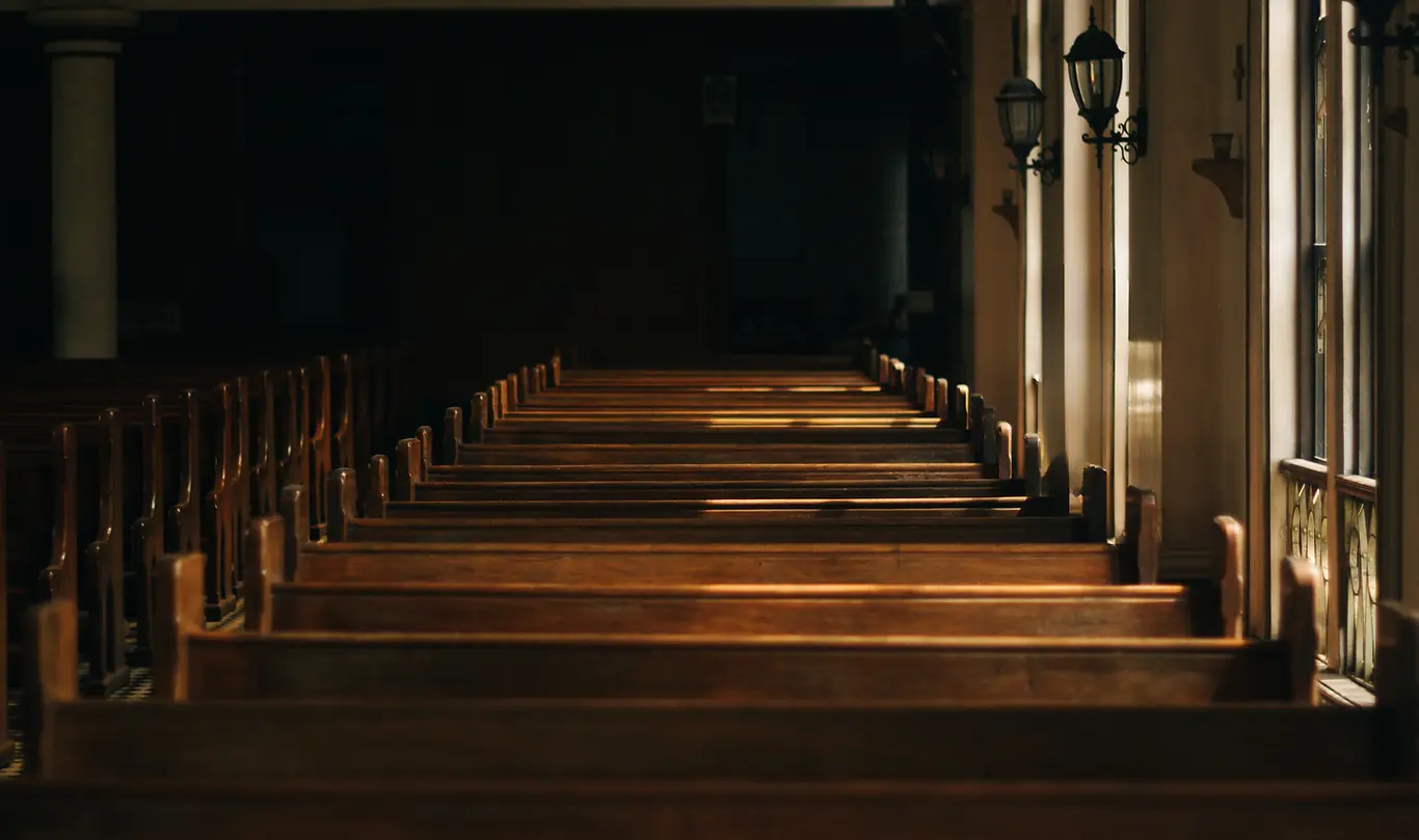 Sunlit wooden church pews